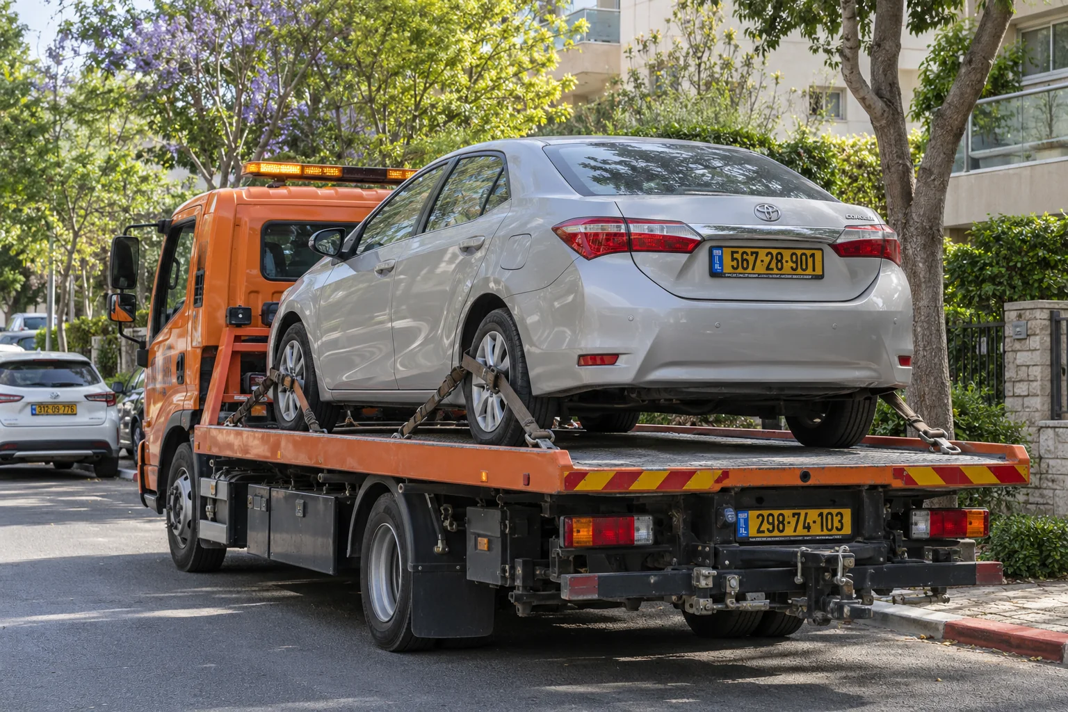 גרירת רכב בכפר סבא עם רכב מקובע על משטח גרר כתום
